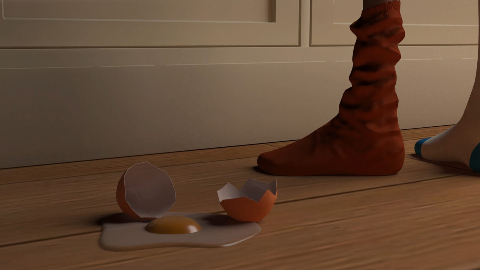 A broken egg lies next to its shell on a wooden floor
