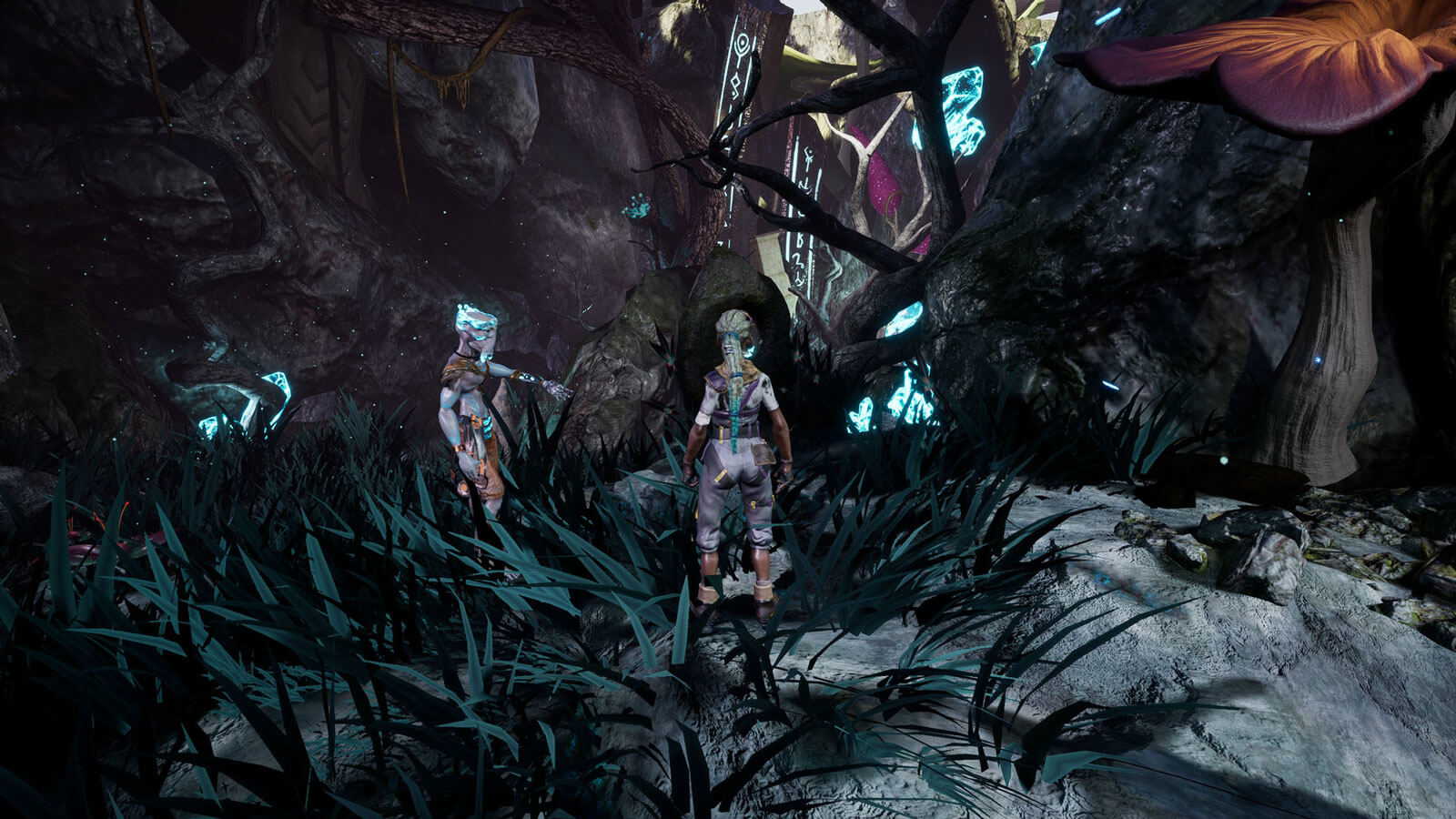 Una mujer y su compañero alienígena se detienen frente a un paraje natural con ruinas al fondo