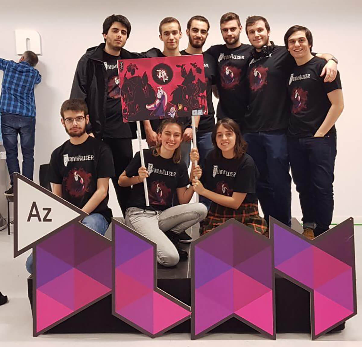 Picture of Team Tannhauser holding a Jera flag in front of an AzPlay sign