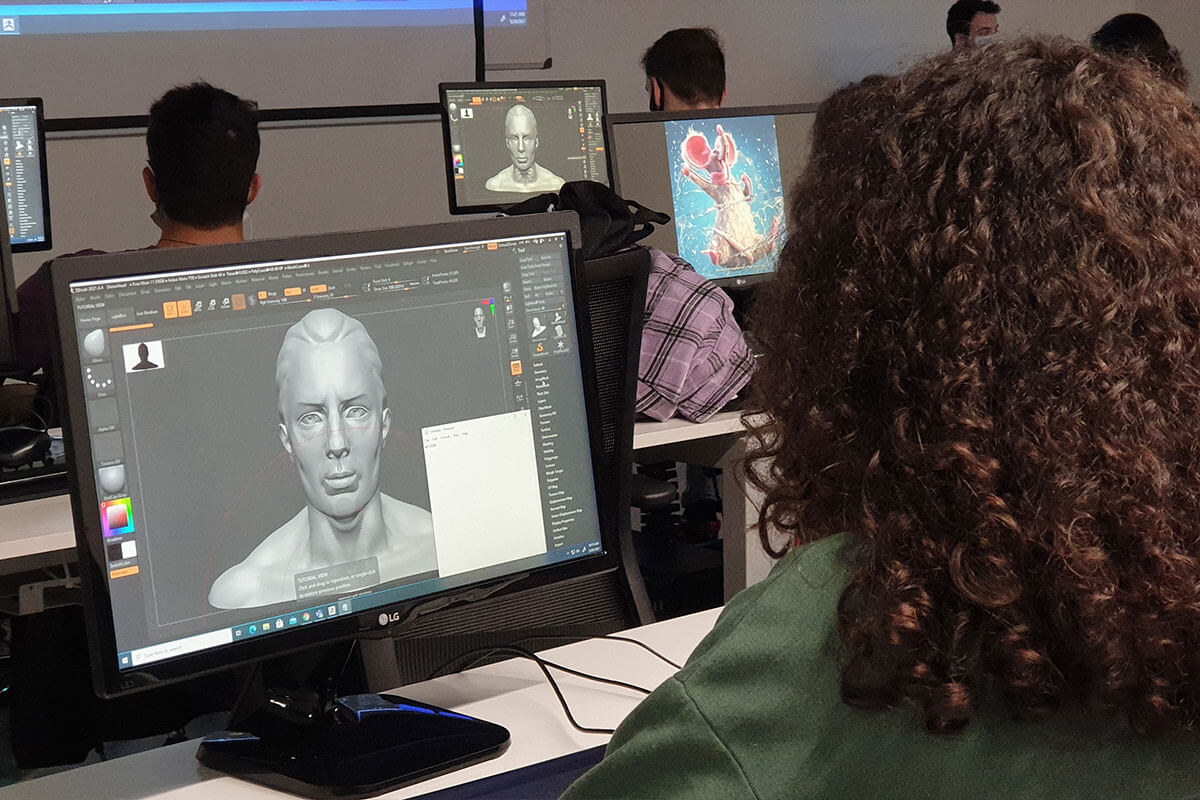 A student uses a 3D modeling program to design the head of a character.