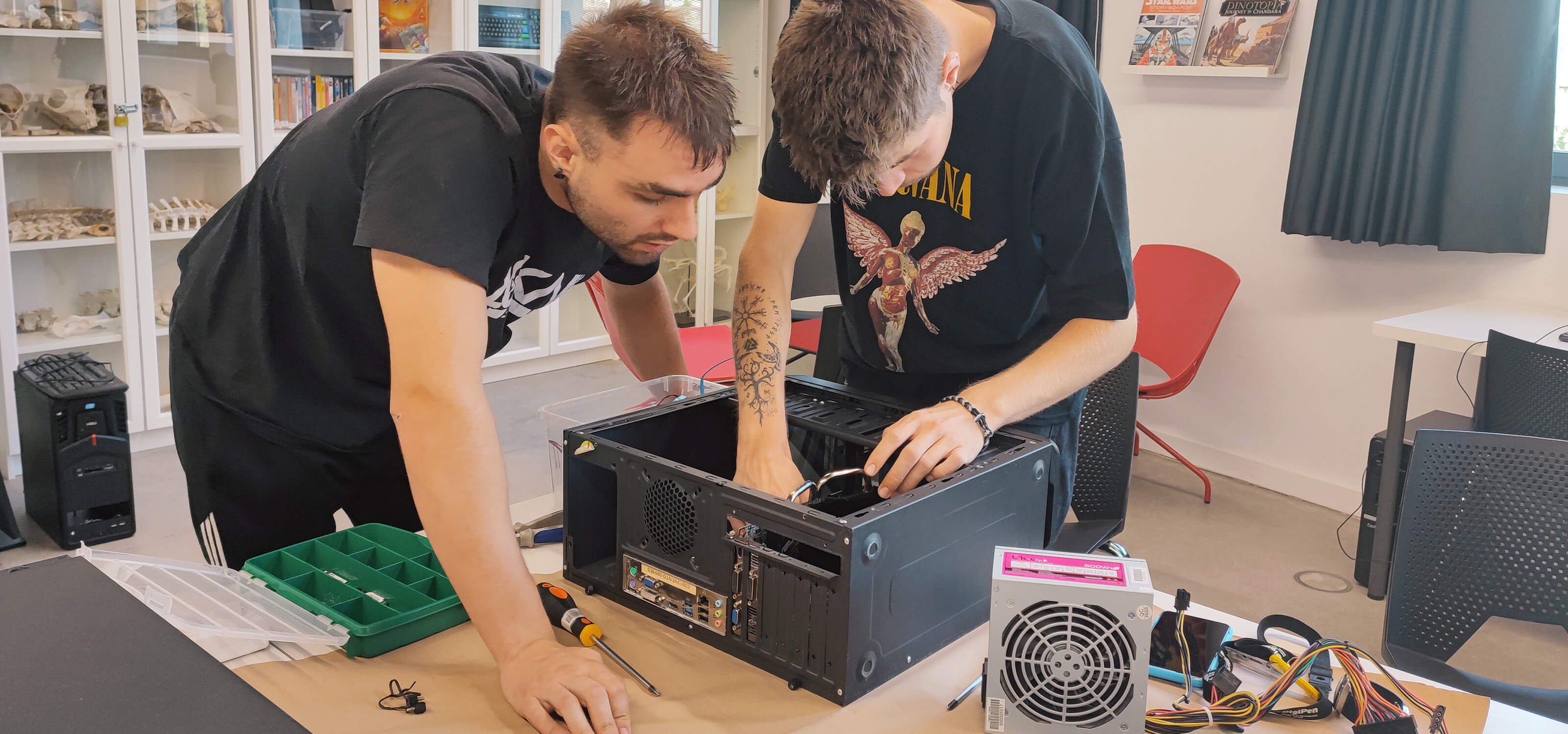 Two students work together to build a PC.