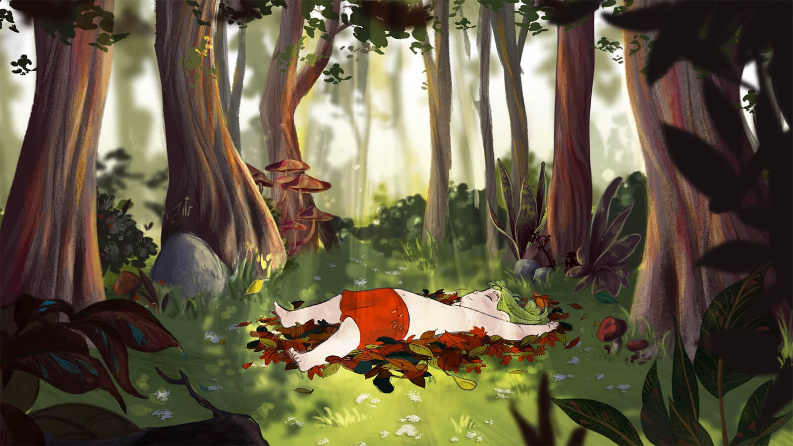 A young child relaxes while laying on top of a pile of leaves within a forest