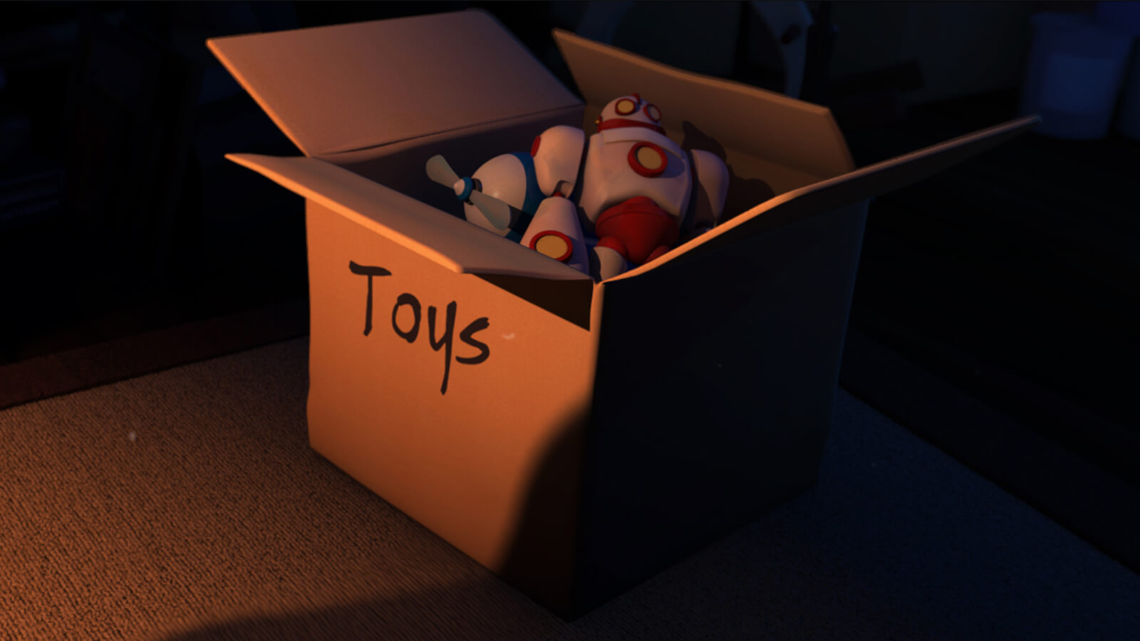 Una caja de cartón en una habitación oscura de lado. Su interior contiene jueguetes de plástico y por fuera tiene la palabra "toys" escrita.