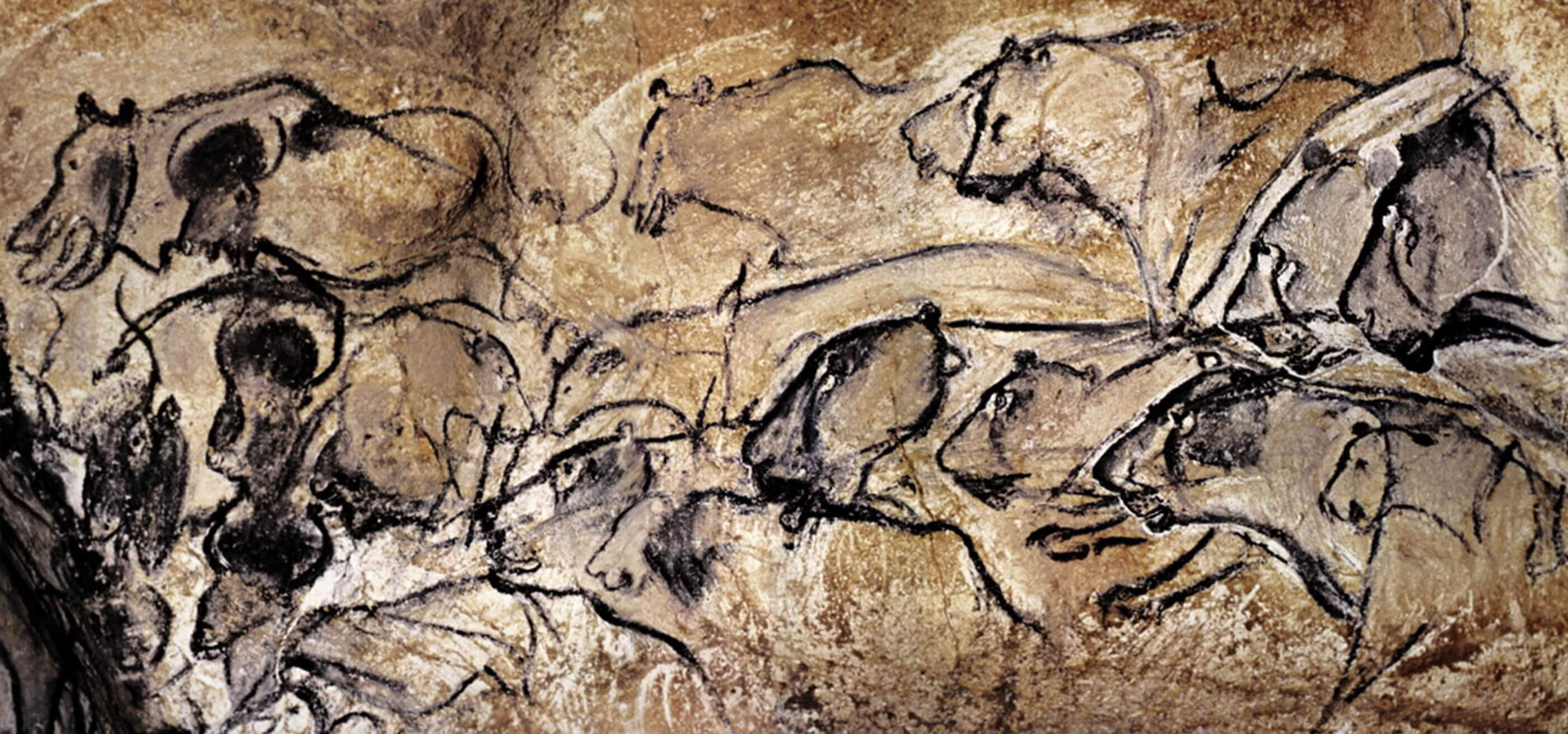 A cave painting depicting a group of animals.