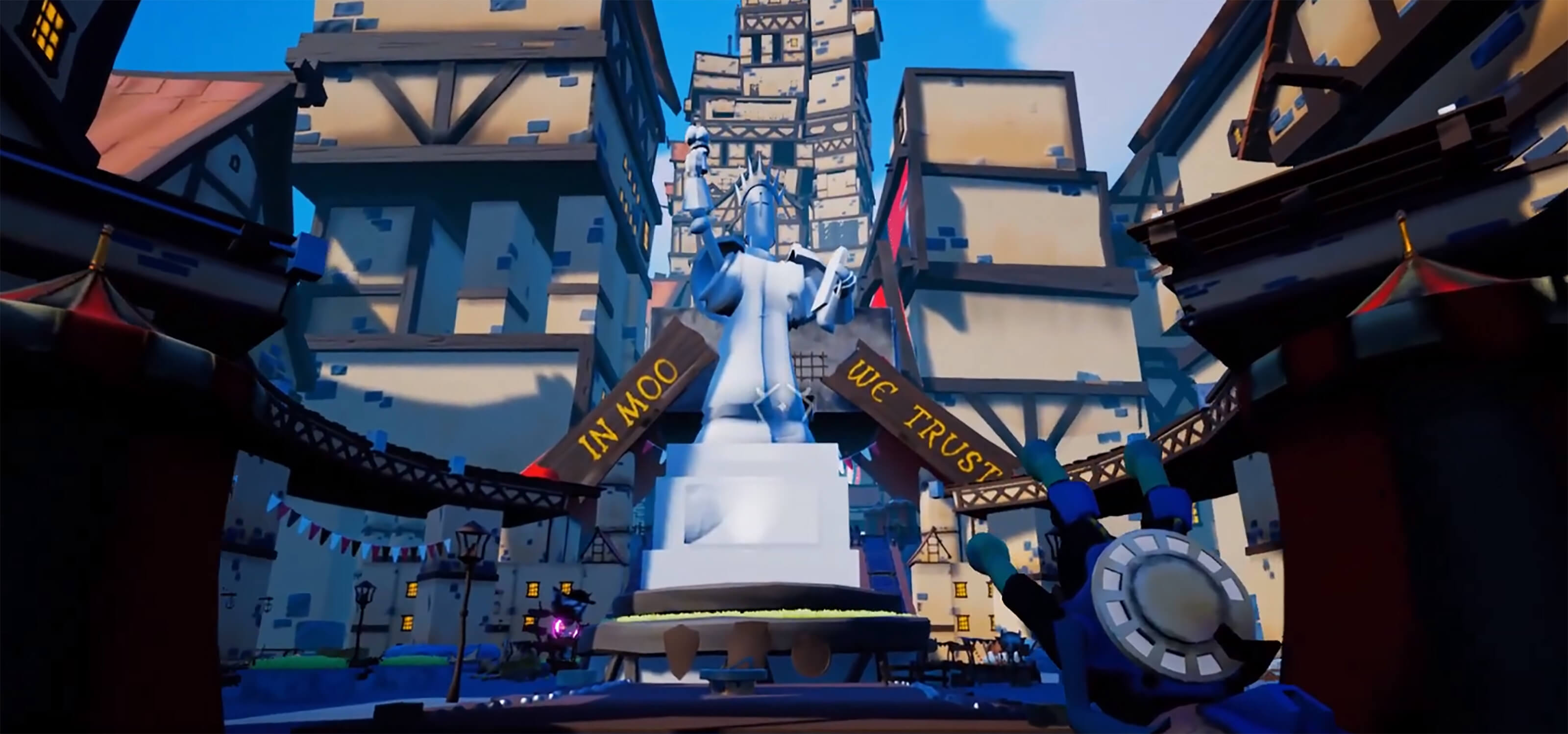 Game screenshot: Large marble statue stands in a medieval town plaza. A sign reads: "In Moo We Trust"