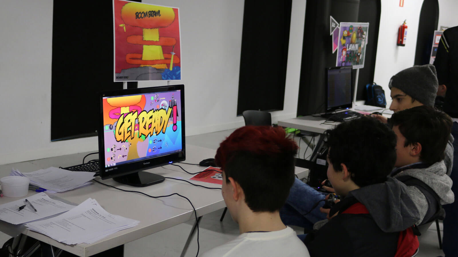 Multiple students play a multiplayer game on a single screen.