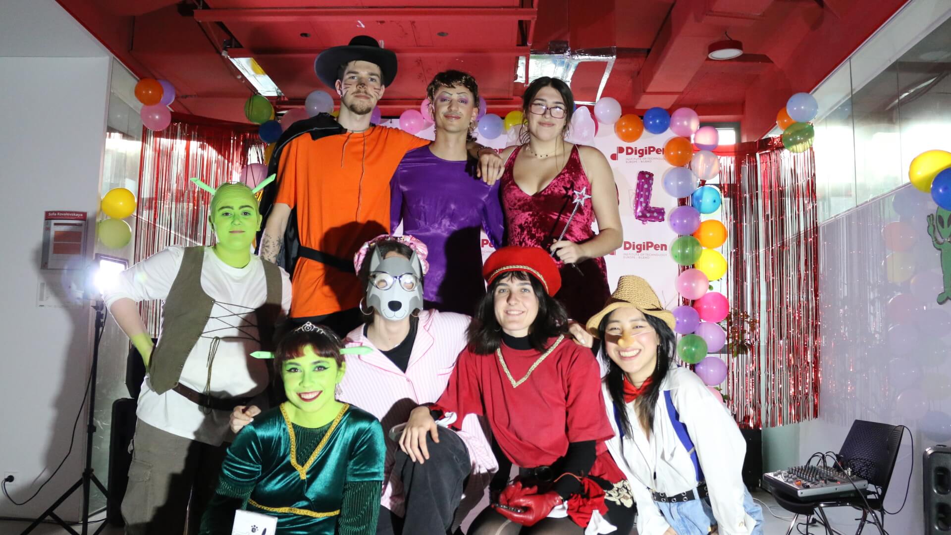Various students pose for a photo dressed in costumes